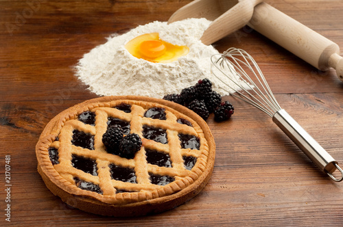 raspberry crostata with flour egg and rolling pin photo