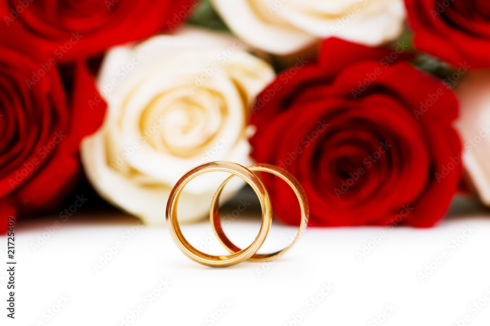 Roses and wedding rings isolated on the white Roses and wedding rings isolated on the white