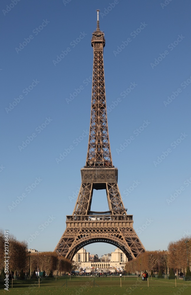 Full view of the Eiffel Tower in Paris with deep blue sky