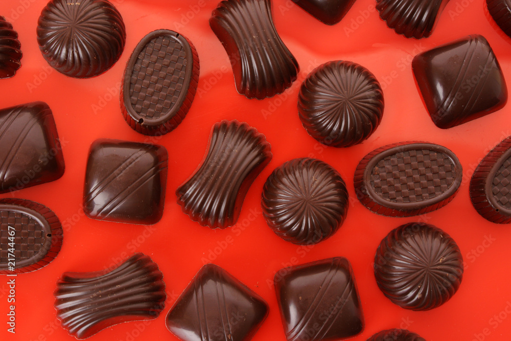 Assorted chocolate candies on red background Assorted chocolate candies on red background