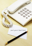 Telephone and memo notes on office desk