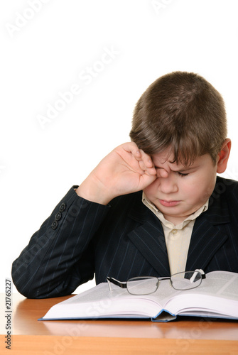 Boy wearing spectacles masses an eye for weariness