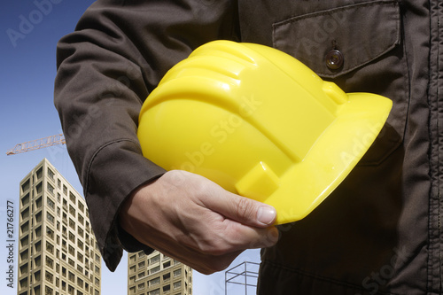 construction worker holding yellow hardhat