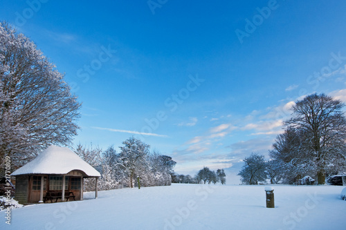 Garden with summerhouse covered in fresh snow