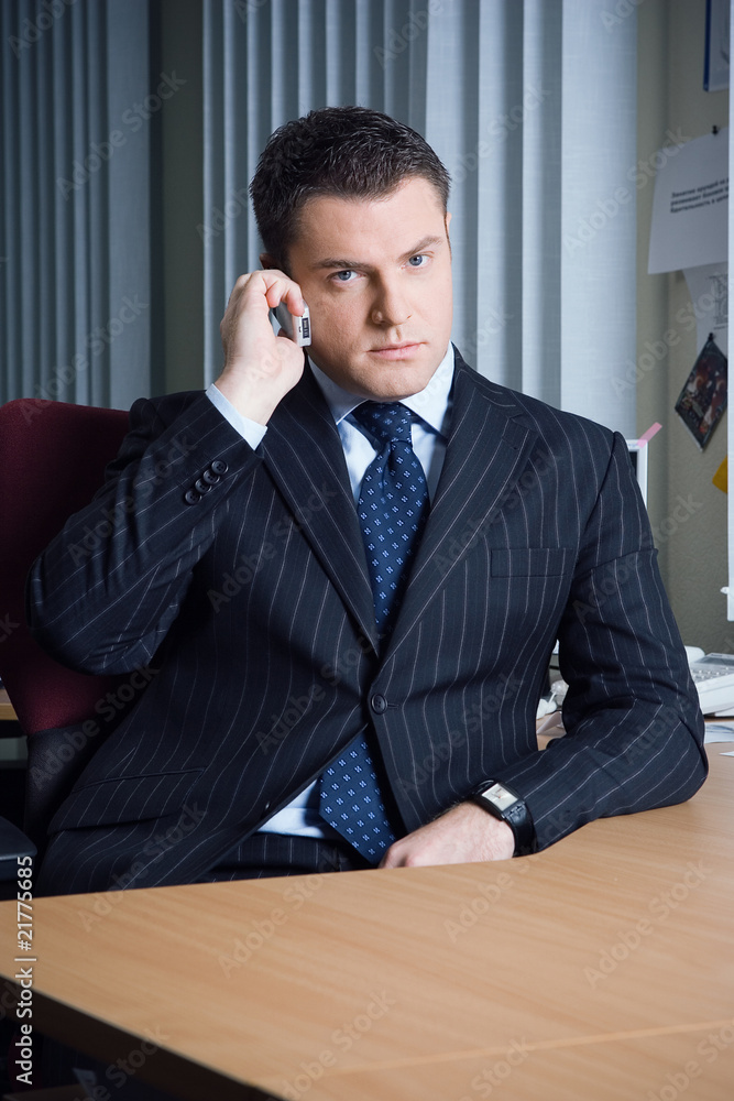 a man talking on the phone in the office a man talking on the phone in the office
