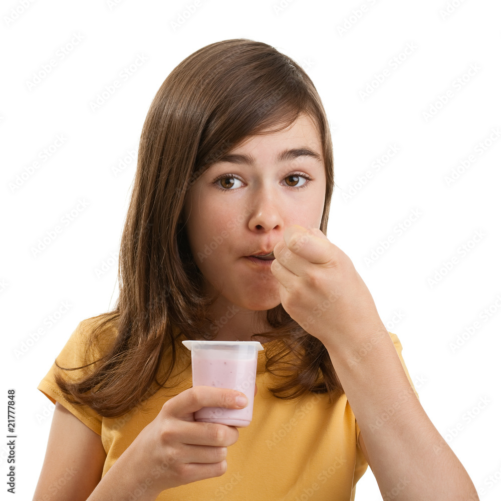 Girl eating yogurt isolated on white background Girl eating yogurt isolated on white background