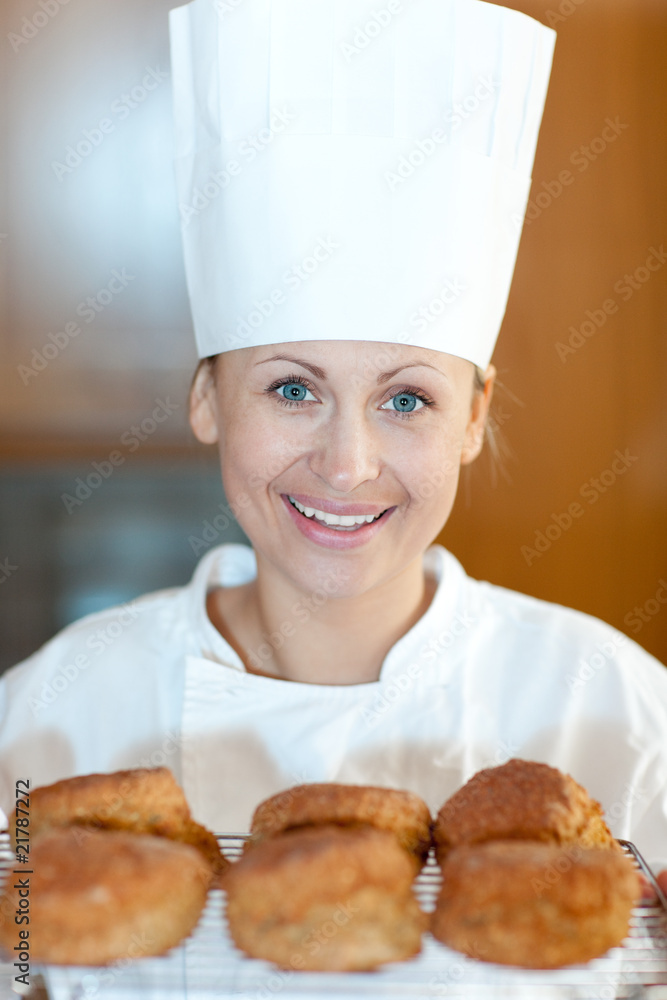 Smiling female chef baking scones Smiling female chef baking scones