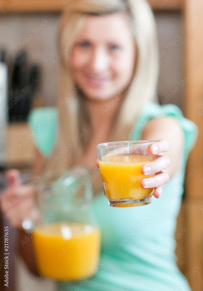 Young woman holding a glass of orange juice while having an heal Young woman holding a glass of orange juice while having an heal