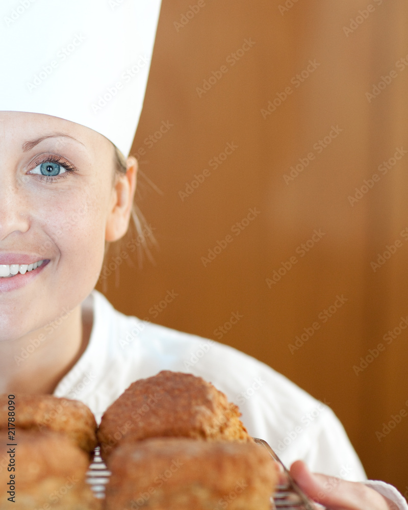 Close-up of a smiling female chef baking scones Close-up of a smiling female chef baking scones