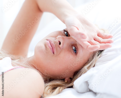 Sick woman lying on a bed