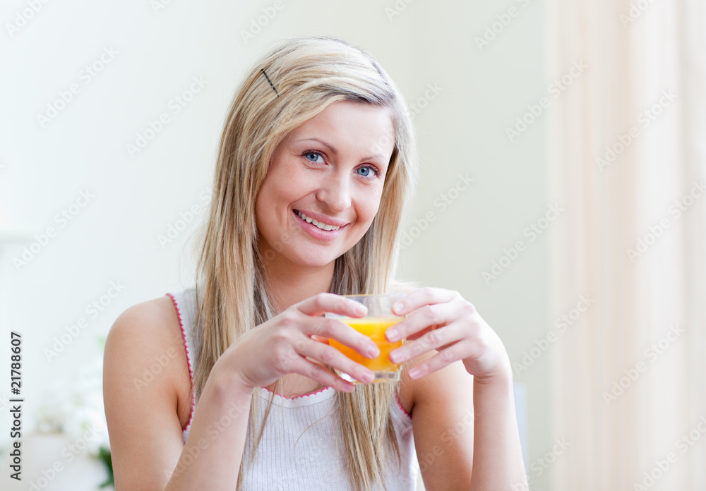 Portrait of a cheerful woman drinking an orange juice Portrait of a cheerful woman drinking an orange juice