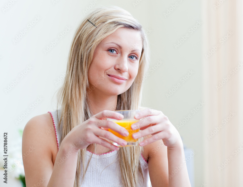 Portrait of an attractive woman drinking an orange juice Portrait of an attractive woman drinking an orange juice