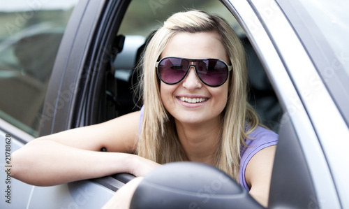 Jolly female driver wearing sunglasses sitting in her car © WavebreakMediaMicro