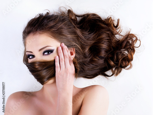 woman covers the face by hairs