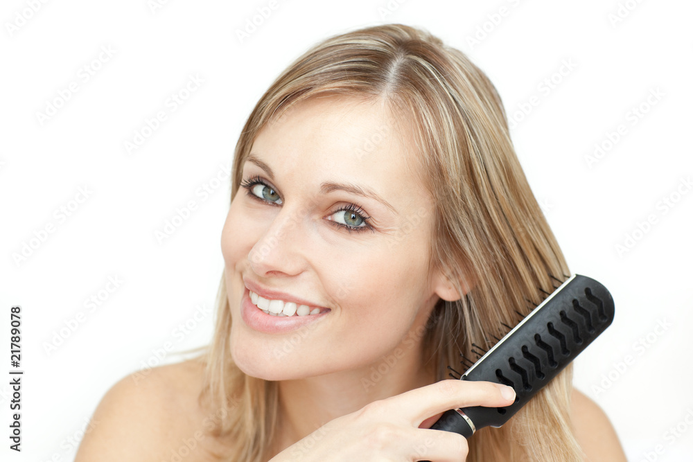 Radiant blond woman brushing her hair