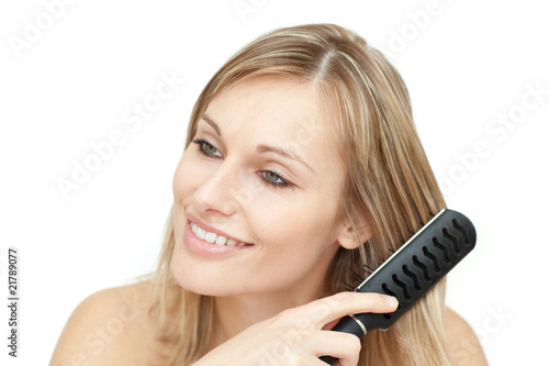 Beautiful blond woman brushing her hair