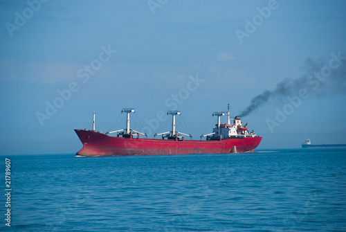 The industrial vessel - the dry-cargo ship goes to port