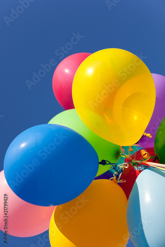Multi colored balloons with a sky background