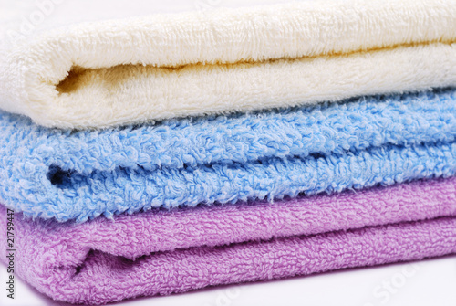 Stack of colorful towels on white