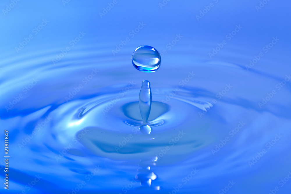 Blue droplet splashing in clear clean water Blue droplet splashing in clear clean water