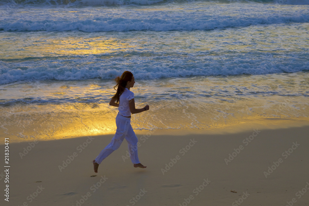 Silhouette of woman, running on decline of sun along ocean coast Silhouette of woman, running on decline of sun along ocean coast
