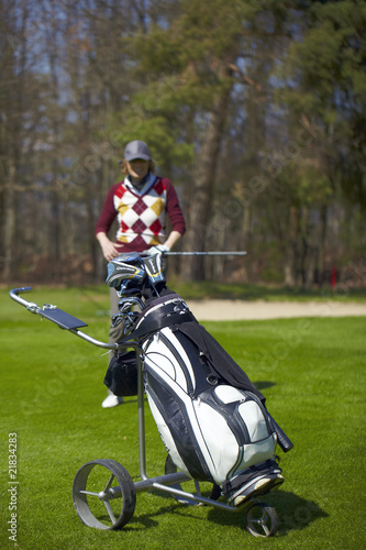 Woman at the golf range with golf bag