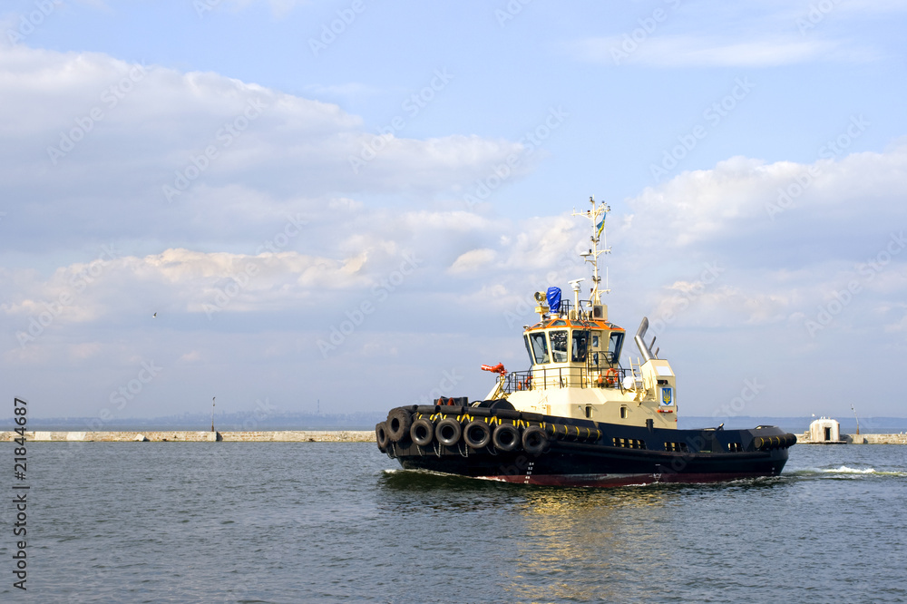 Tug boat is moving in the port