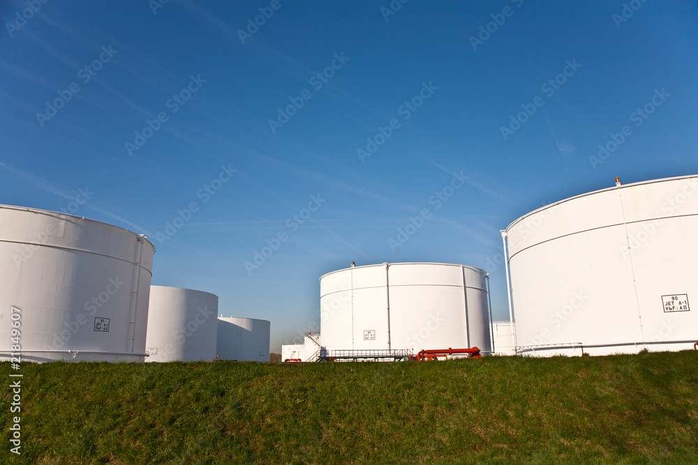 white tanks in tank farm with blue sky white tanks in tank farm with blue sky