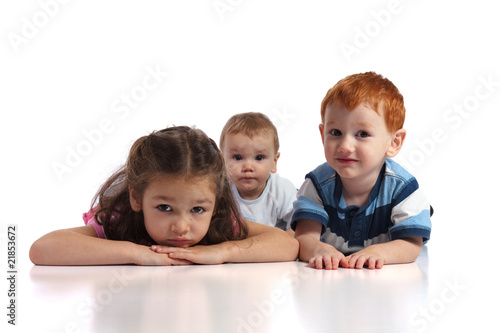 Three kids lying on floor
