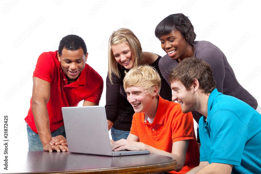 Multi-racial college students sitting around a computer Multi-racial college students sitting around a computer