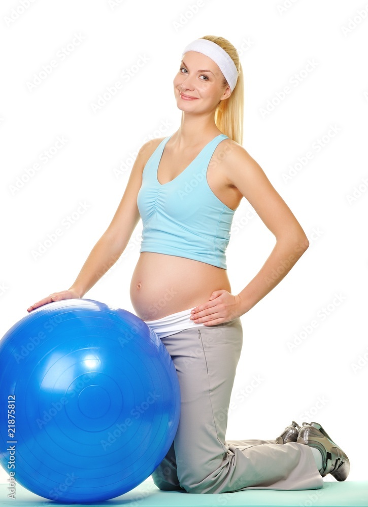 Young pregnant woman making exercise with a fitness ball . Young pregnant woman making exercise with a fitness ball .