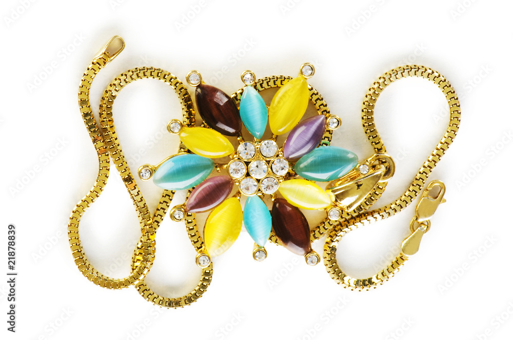 Golden chain and brooch isolated on white Golden chain and brooch isolated on white