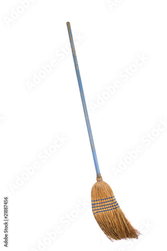 Old straw broom ready to sweep isolated on white background