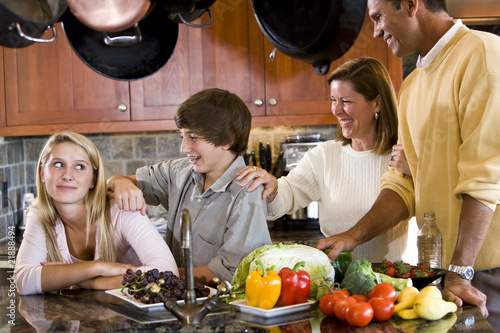 Happy family with teenagers smiling in kitchen