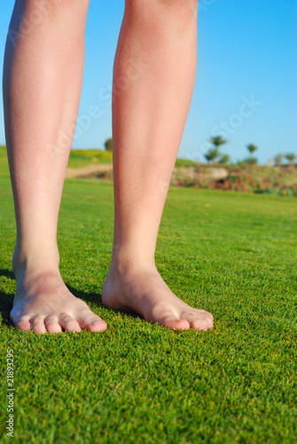 female legs on grass