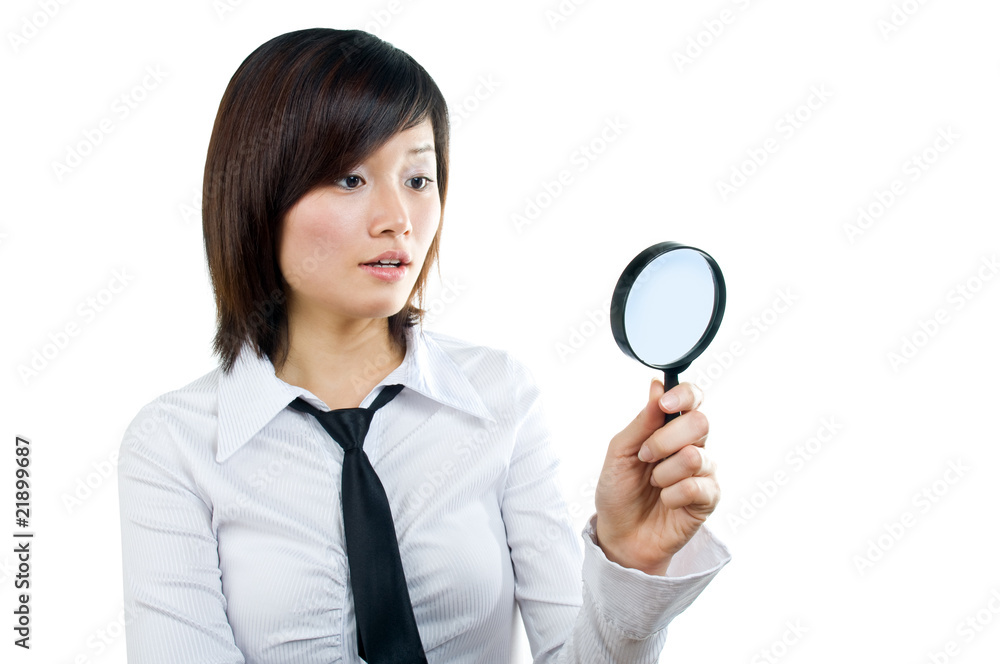 Businesswoman searching using magnifying glass Businesswoman searching using magnifying glass
