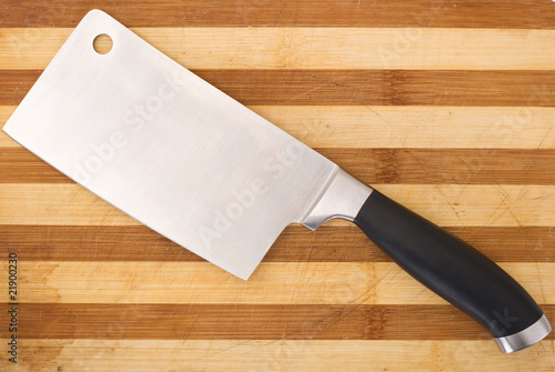 meat cleaver isolated over wooden background photo