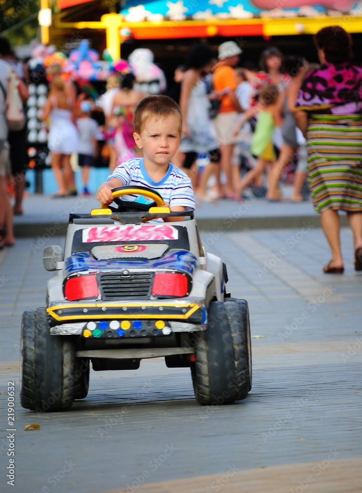 boy in the toy car