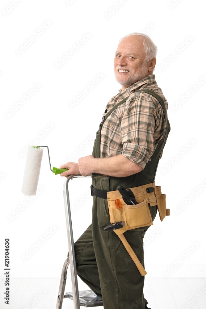 Senior man painting home Senior man painting home