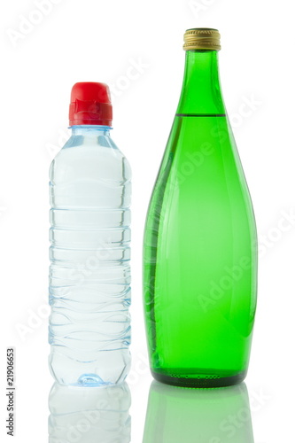 Bottles of mineral water reflected on white background