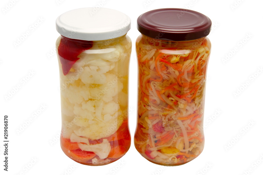 Glass jars with marinated vegetables  isolated on the white back