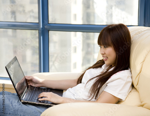 young woman working at home with laptop