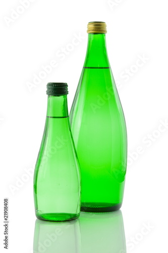 Bottles of mineral water reflected on white background