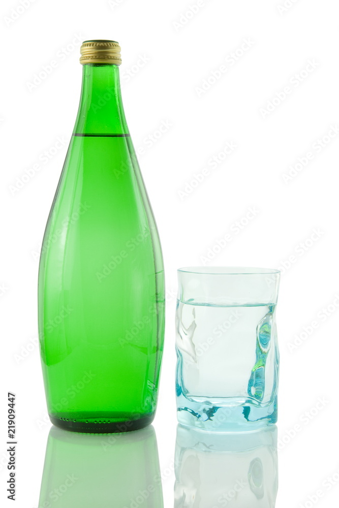 Bottle and glass of mineral water reflected on white background