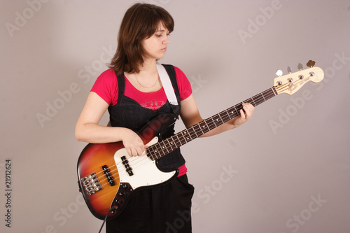 young beautiful woman with a bass guitar