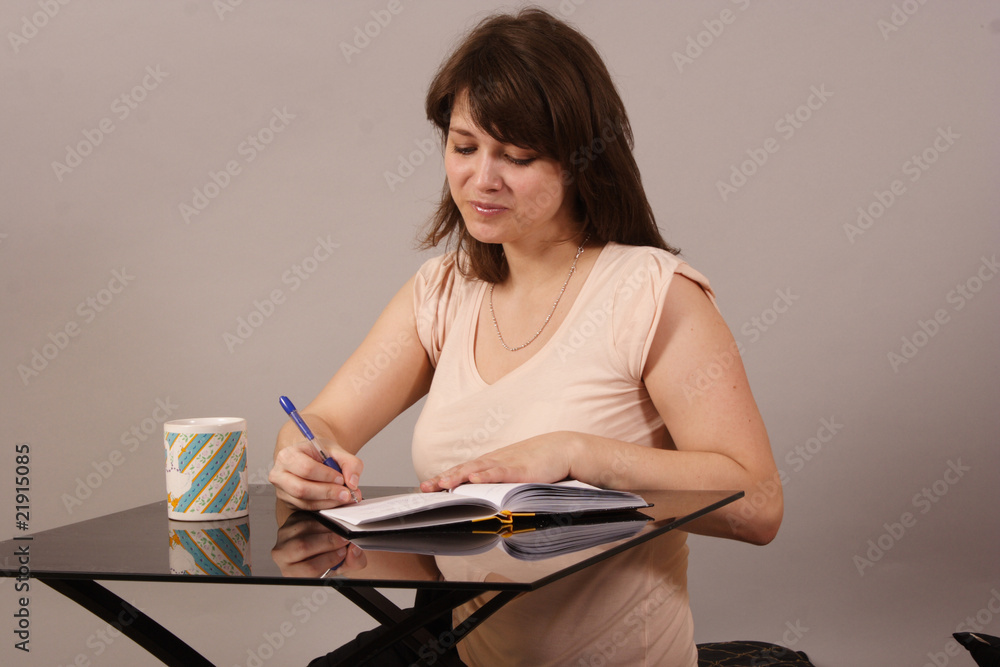 young beautiful woman writing in her diary young beautiful woman writing in her diary