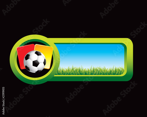 soccer ball with penalty cards on countryside banner