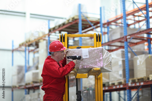 worker with bar code reader working in warehouse