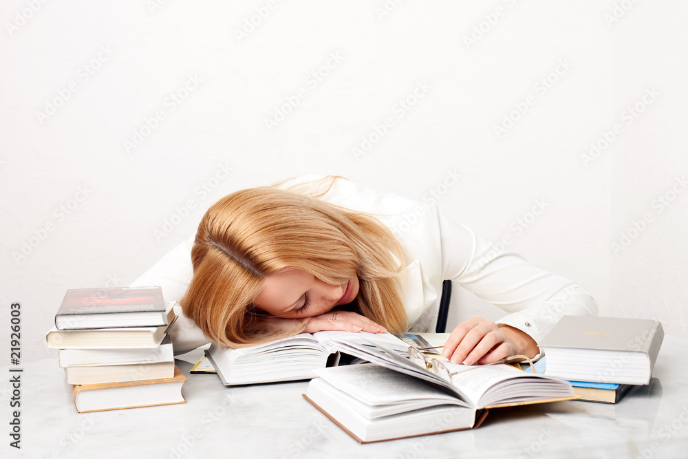 Young woman falling asleep while studying Young woman falling asleep while studying