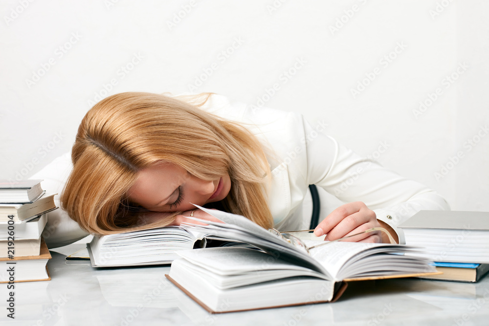 Young woman falling asleep while studying Young woman falling asleep while studying